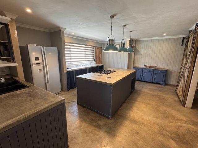 Kitchen with full-size fridge-freezer, island and barn sliding door, Stoneridge Cottage