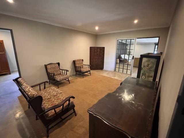 Sitting room with armchairs and a polished concrete floor